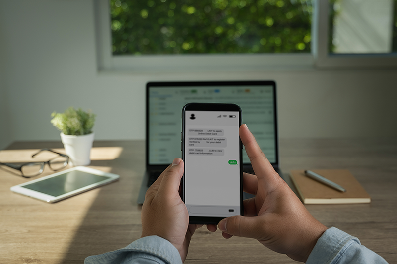 man-holding-mobile-phone-with-text-messages-showing