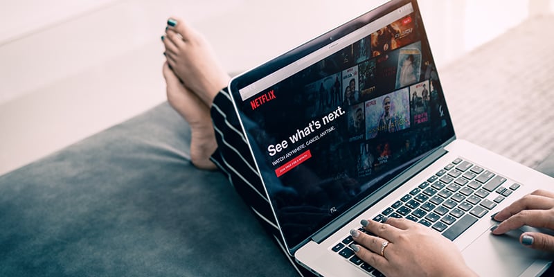 woman-using-laptop-looking-at-netflix